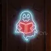 24x19 Blue Ghost Reading Book Neon Sign – Spooky Cute LED Wall Light for Halloween, Libraries, Bookstores, Reading Nooks, Kids’ Bedrooms, Study Rooms, and Unique Gift for Bookworms & Ghost Lovers 1