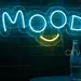 “MOOD – A Creative and Playful Logo Design with Bold Blue Lettering and a Bright Yellow Smile Beneath, Capturing Positive Energy, Cheerful Vibes, and the Joyful Spirit of Uplifting Human Emotions” 2